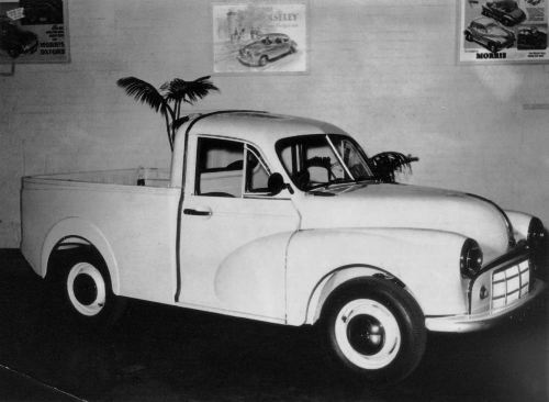 Posters on the showroom wall advertise the Morris Oxford the new Minor and
