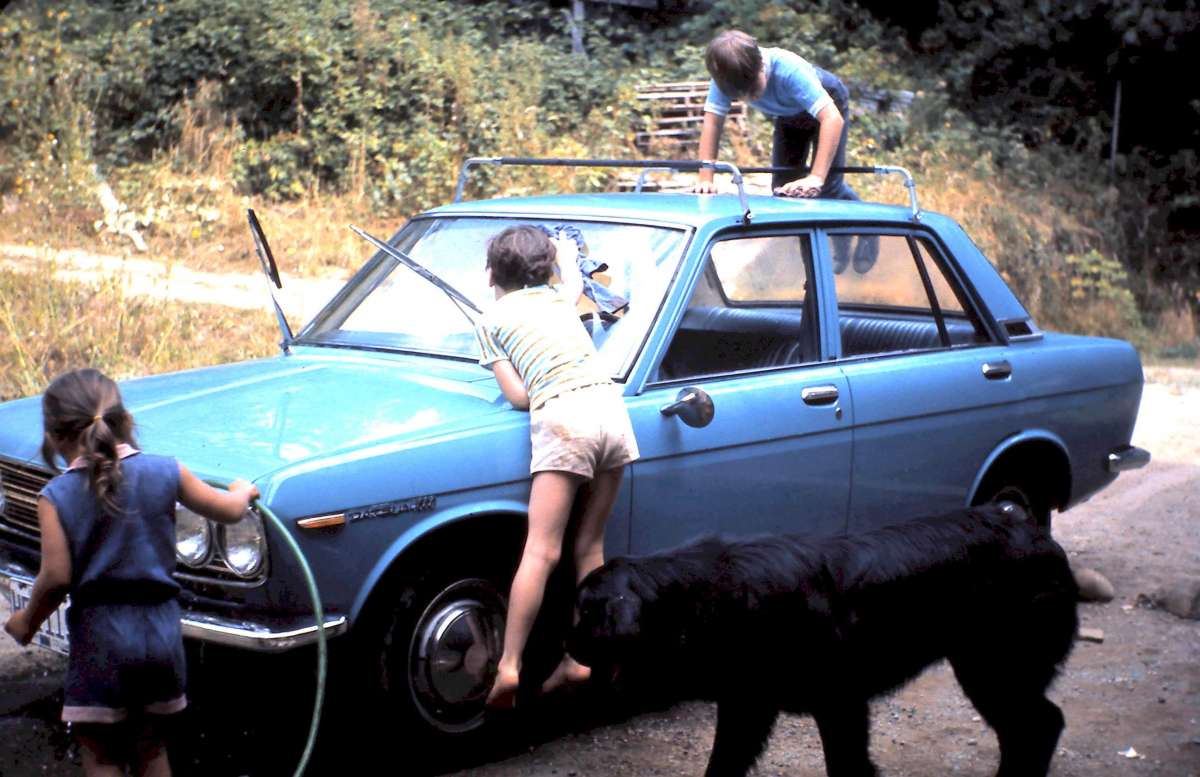 (Adam Browne’s second Kids CC post.)  Me (on the roof) with my brother and sister (and Juno the dog) washing the family Datsun in August 1970, near Vancouver.