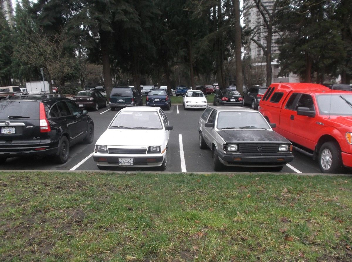 Cohort Outtake: Two Small Cars Keeping Company canadiancatgreen caught a couple of little 1980s imports huddling together for safety amongst all those big, mean trucks and CUVs.