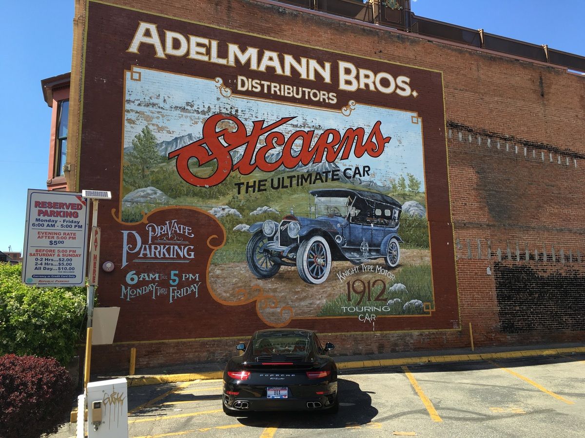 Roadside Outtake: The Ultimate Car Indeed I was in Boise, Idaho recently and while walking around the very inviting downtown area came across this parking lot with a wonderful juxtaposition of advertisement vs actual car.