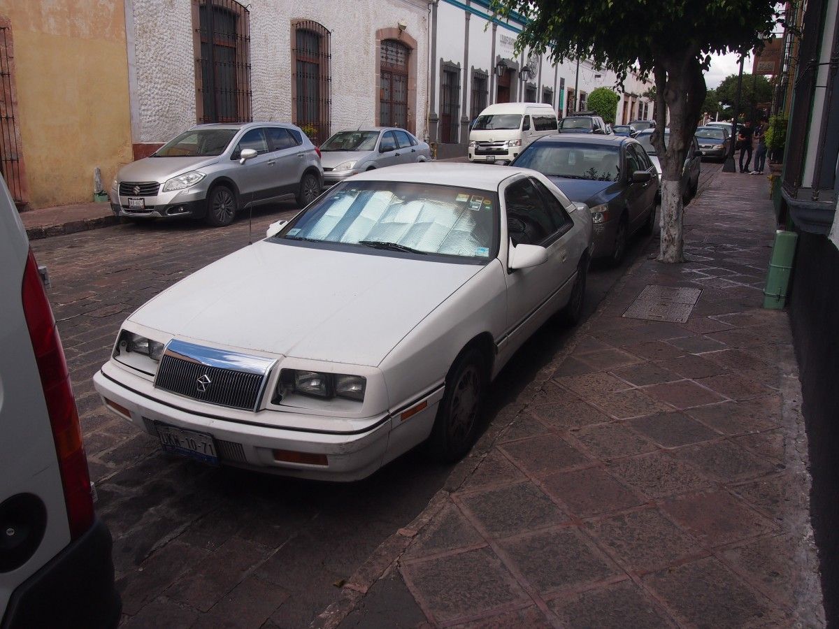 (first posted 12/12/2016)    This rebadged LeBaron coupe shared a name with a Rolls-Royce and, in one way, echoed another Rolls-Royce. The Camargue coupe ended production just a year prior to [&hellip;]