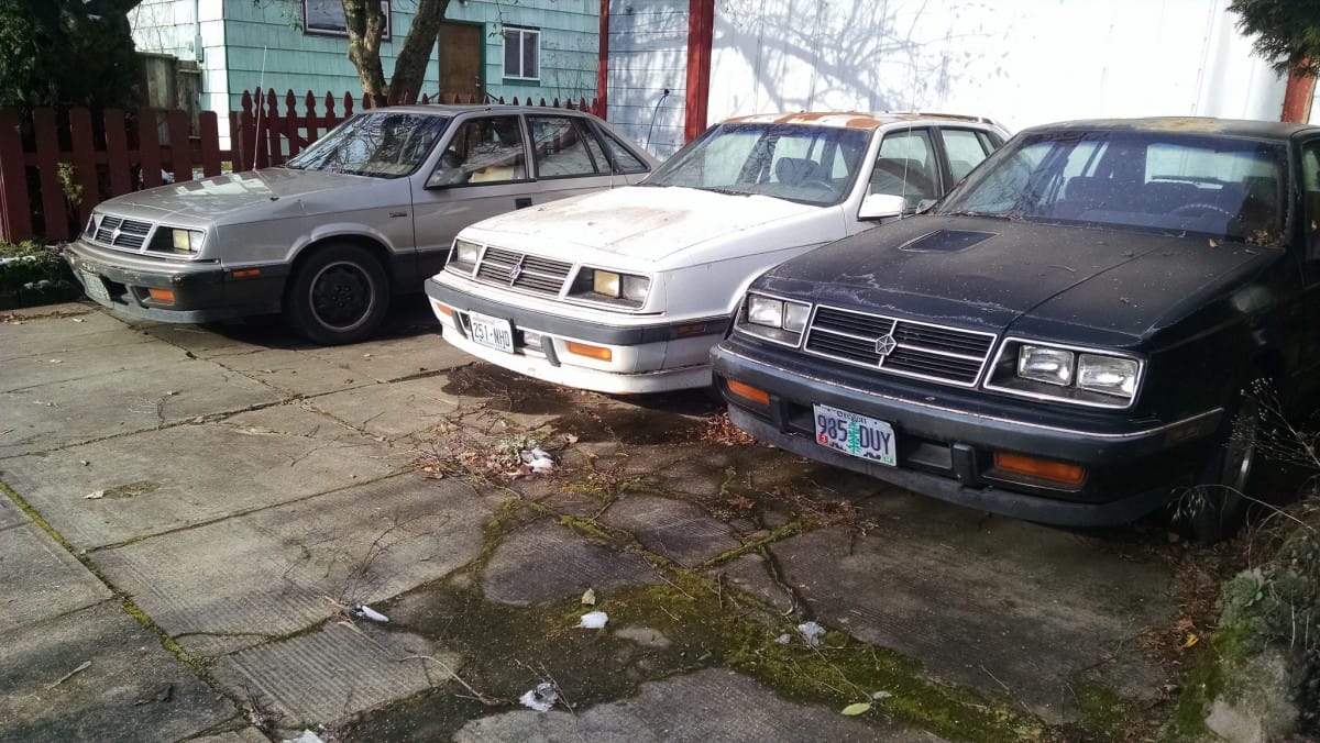 I’ve been having some fun finding multiples of the same car in one shot. But Teddy has outdone me with this three-fer; someone is fond of Dodge Lancers. Looks like [&hellip;]