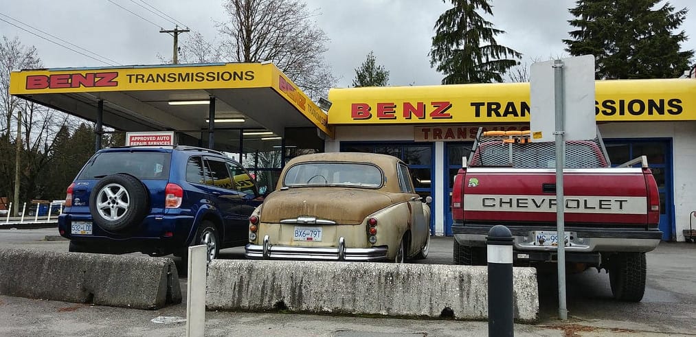 Cohort Outtake: A Daimler at Benz Transmissions Posted at the Cohort by Foden Alpha Here’s serendipitous combination of car and shop name. Too bad there’s no Mercedes. Maybe there’s one in the shop.