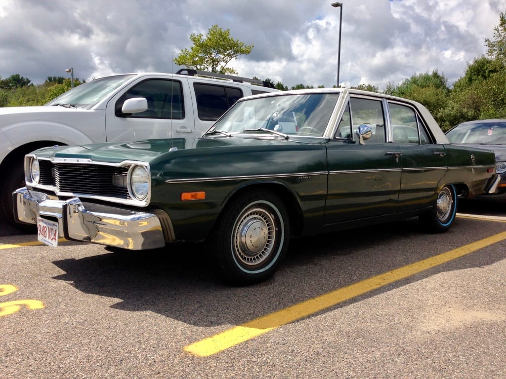 Photo of a dark green 1976 Dodge Dart four-door sedan with a white vinyl roof