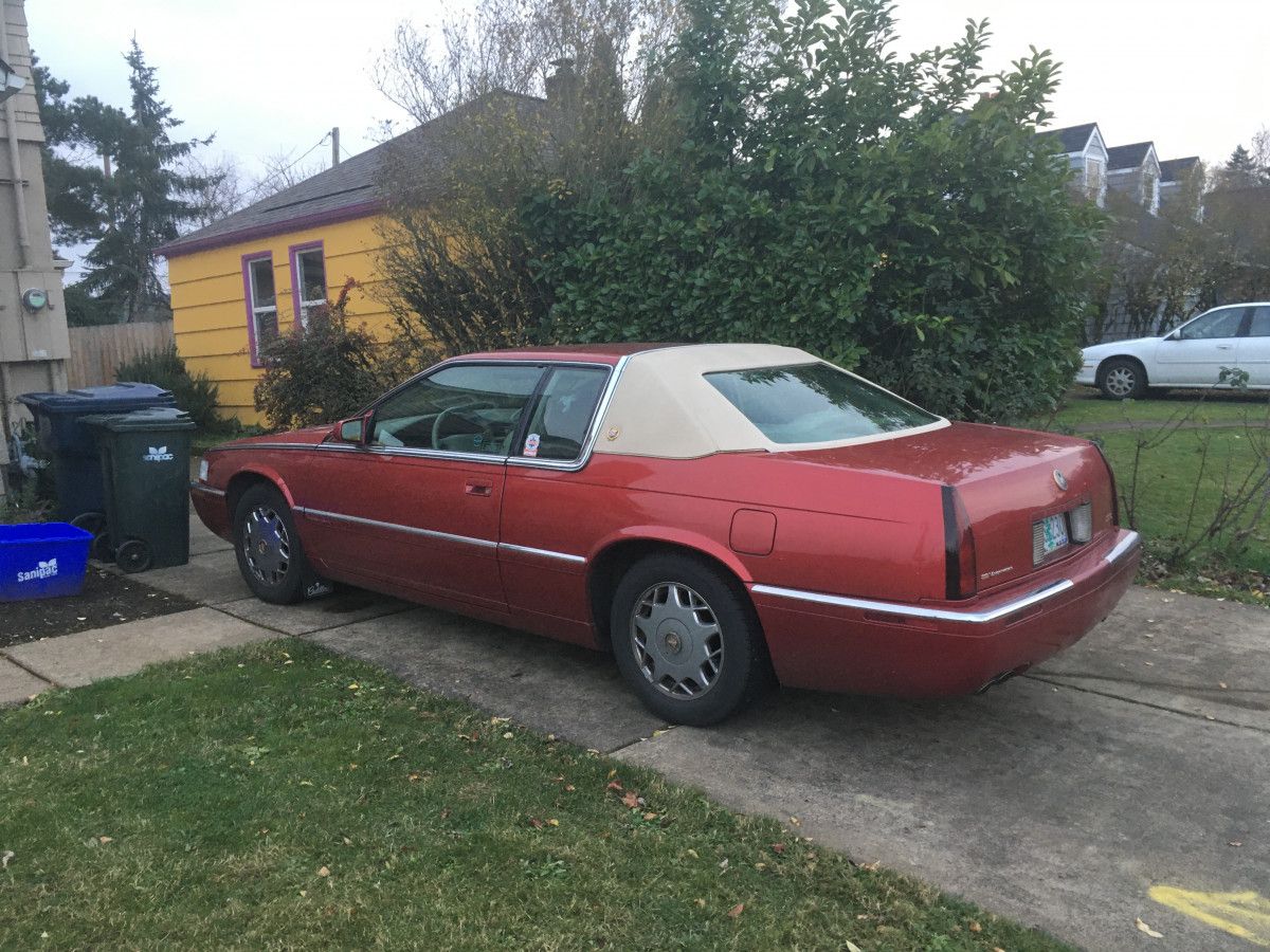 Photo of a red 1995 Cadillac Eldorado with a tan vinyl landau top