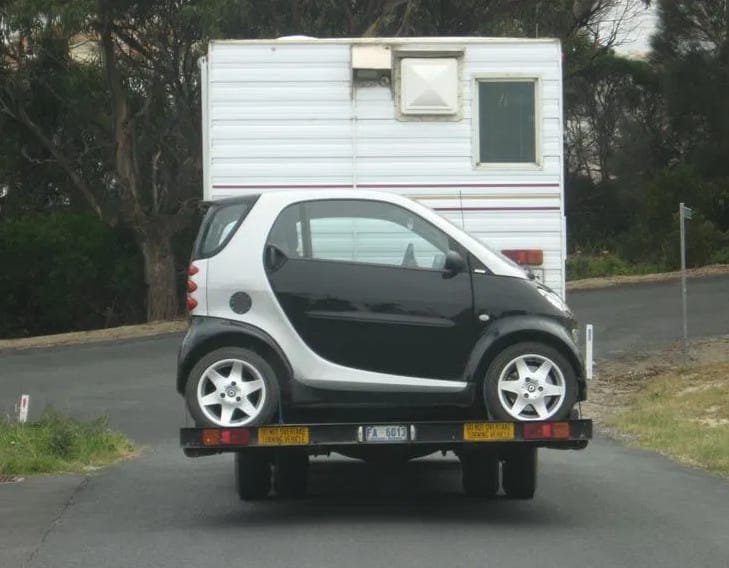 (first posted 6/23/2014)   Why carry a spare tire on the back of one’s RV when a spare car fits almost as well? Posted at the Cohort by Johnh875.