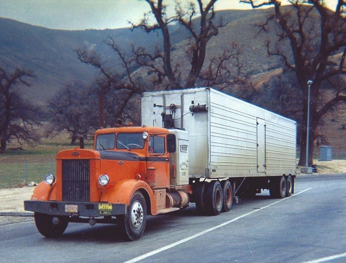 This shot from the mid-late 1960’s shows a Peterbilt 350/351 from the late 1940’s in a quintessentially California shot: a rest area near Lebec, with towering bare California oak trees [&hellip;]