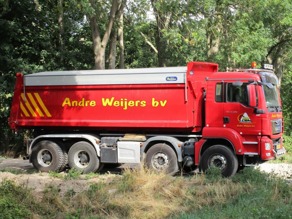 A red truck against a green background. Complementary colors, opposites of each other on the color wheel. This MAN stood out like a fire truck on an ocean beach, it [&hellip;]