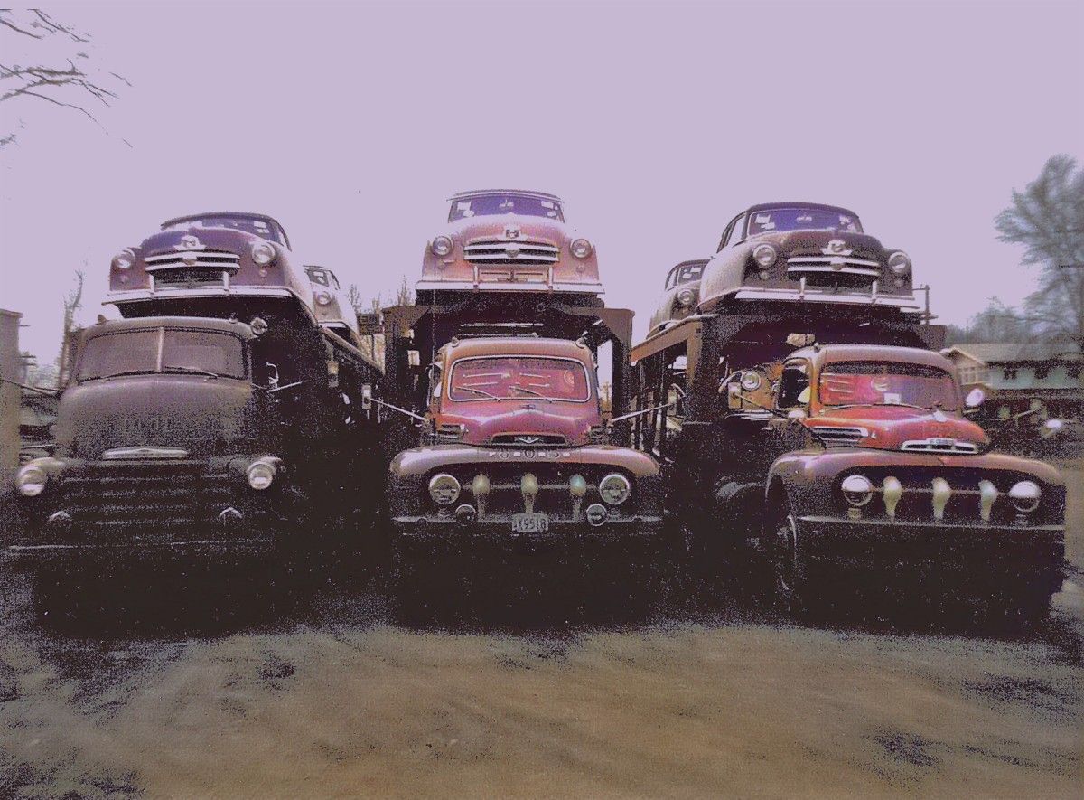 Great picture. The trucks are the stars here, especially the two Fords, a ’51 and a ’52 (I think). Is that ’52 on the right sporting those chrome covers over [&hellip;]