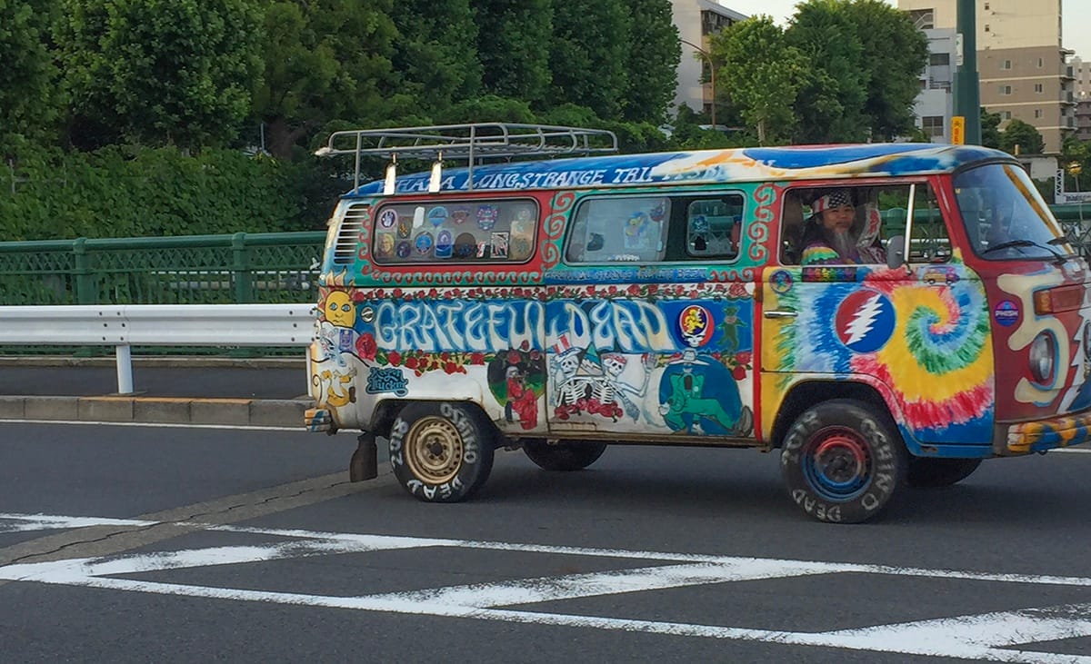 In-Motion Classic: Hippie Bus, As Interpreted From Afar I was almost too late—but not quite!—to snag a pic of this fab VW Bus and its well-matched driver on a June afternoon in 2018.