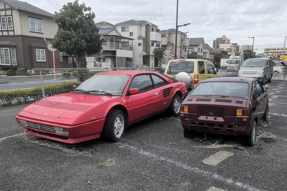 A classic Ferrari and an iconic Suzuki, both unlicensed but not yet completely derelict, gathering weeds in a parking lot? Yep, this is Tokyo all right. Of the twofers we’ve [&hellip;]