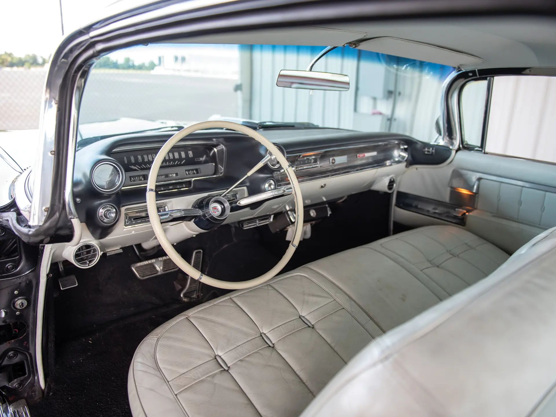 1960 Cadillac Eldorado Seville: An Artifact Of The Tomorrow That Never Was 17 Dashboard of a 1960 Cadillac Eldorado Seville with white leather upholstery, viewed through the driver's door