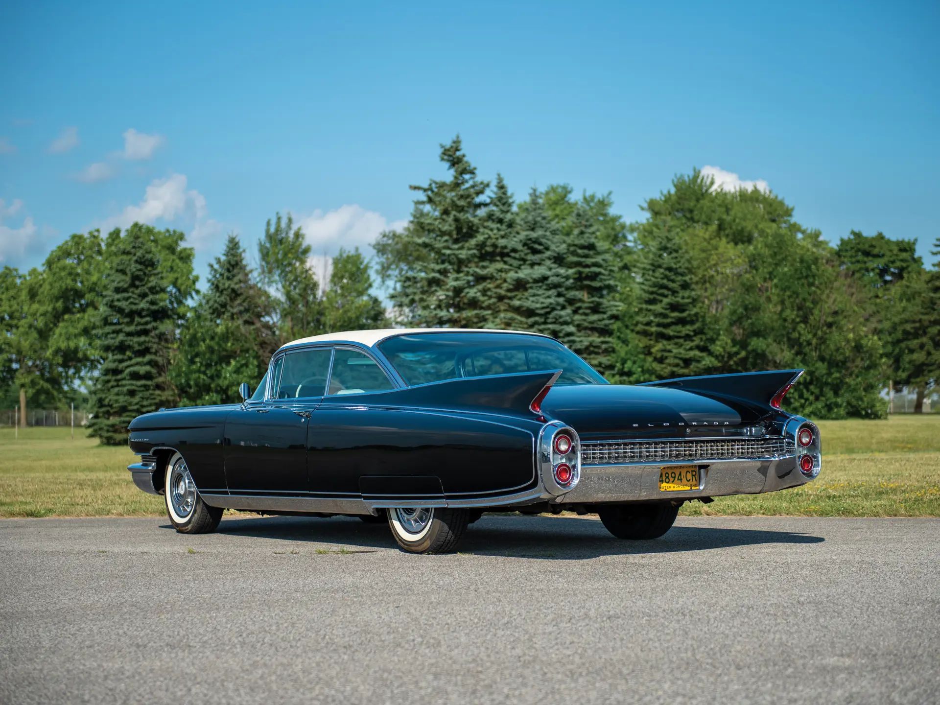 1960 Cadillac Eldorado Seville: An Artifact Of The Tomorrow That Never Was 15 Rear 3q of a black 1960 Cadillac Eldorado Seville with white vinyl top