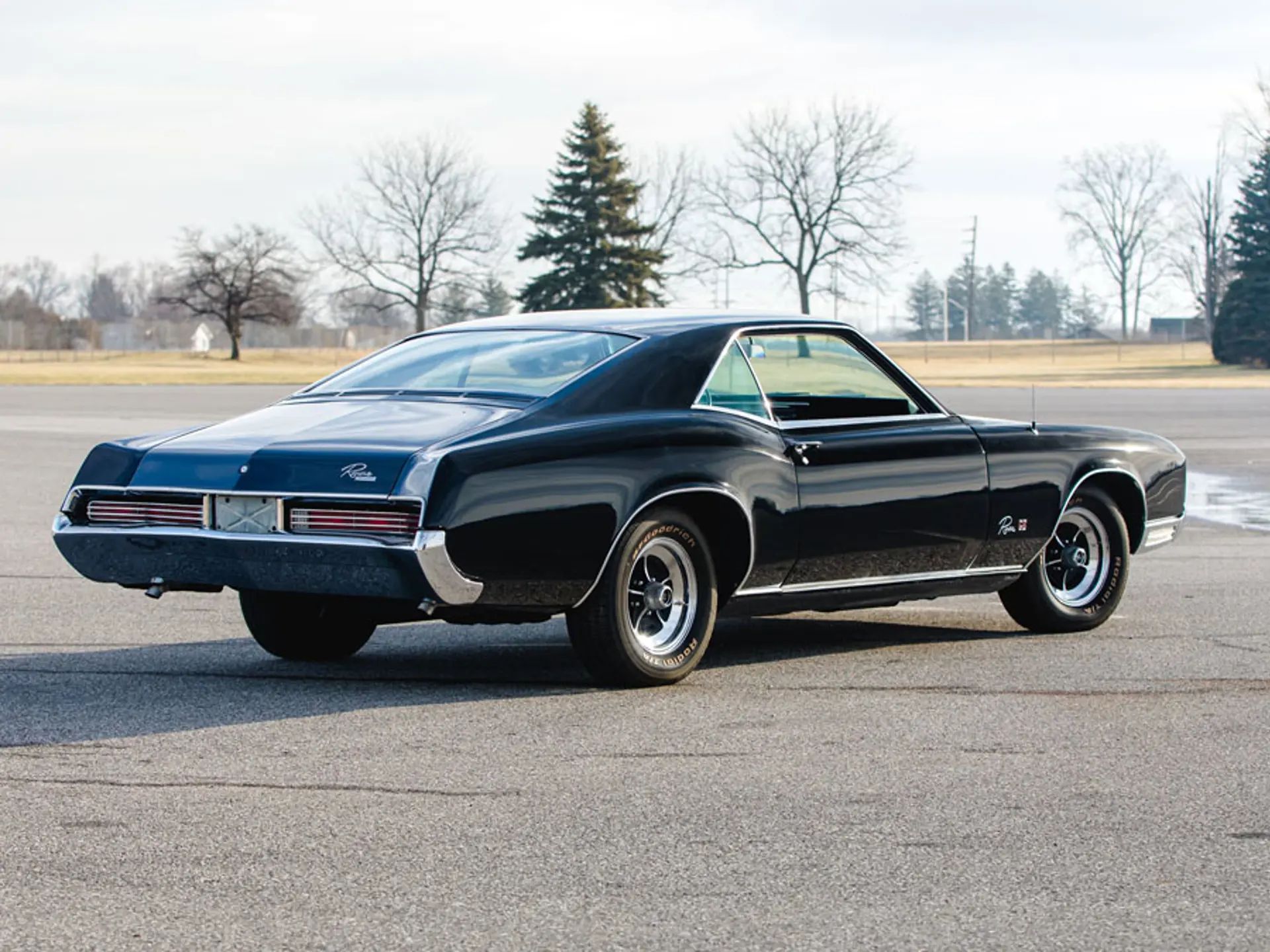 1966 Buick Riviera Versus 1966 Oldsmobile Toronado – Closely Related, Yet So Different (Part 2) 29 Right rear 3q view of a Regal Black 1966 Buick Riviera GS with styled wheels and RWL tires