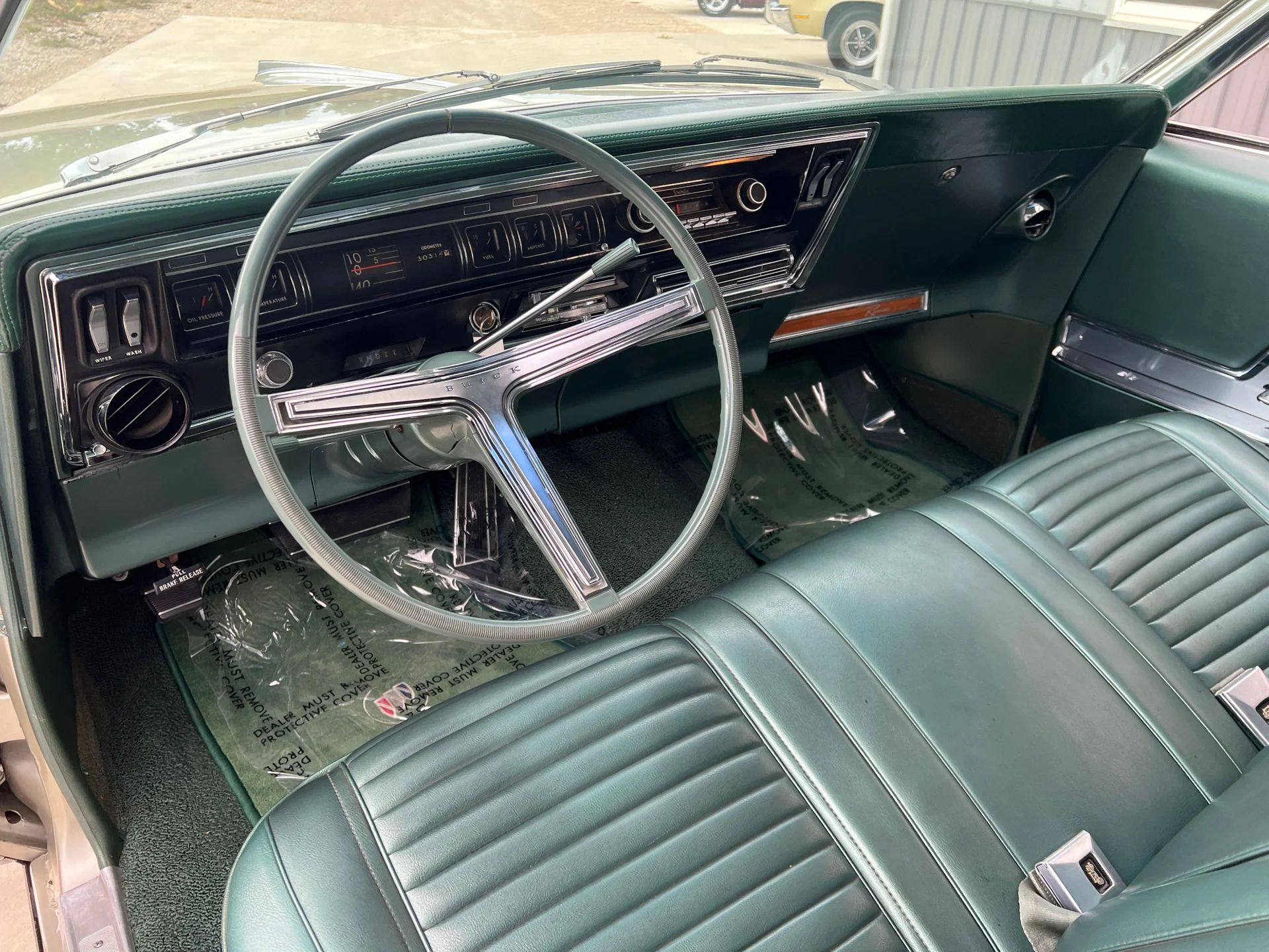 1966 Buick Riviera Versus 1966 Oldsmobile Toronado – Closely Related, Yet So Different (Part 2) 16 Dashboard of a 1966 Buick Riviera with green vinyl Custom Trim and Strato Bench seat