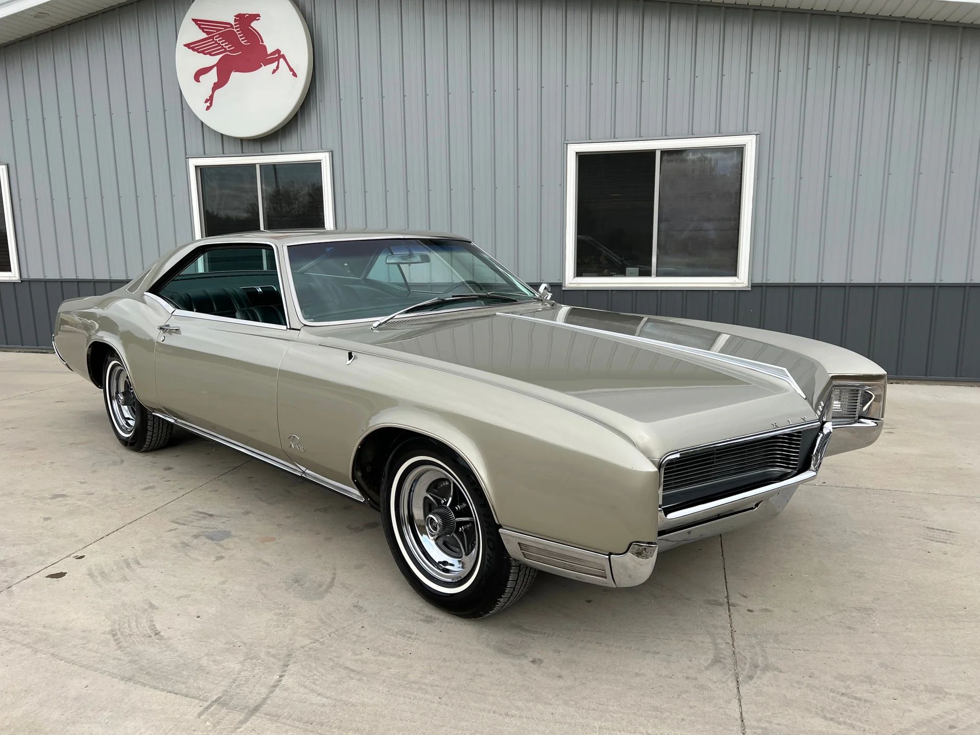 1966 Buick Riviera Versus 1966 Oldsmobile Toronado – Closely Related, Yet So Different (Part 1) 3 Right front 3q view of a Silver Green 1966 Buick Riviera with styled steel wheels