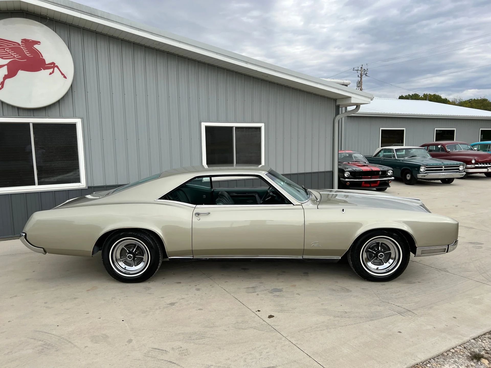 1966 Buick Riviera Versus 1966 Oldsmobile Toronado – Closely Related, Yet So Different (Part 1) 7 Right side view of a Silver Green 1966 Buick Riviera with styled steel wheels