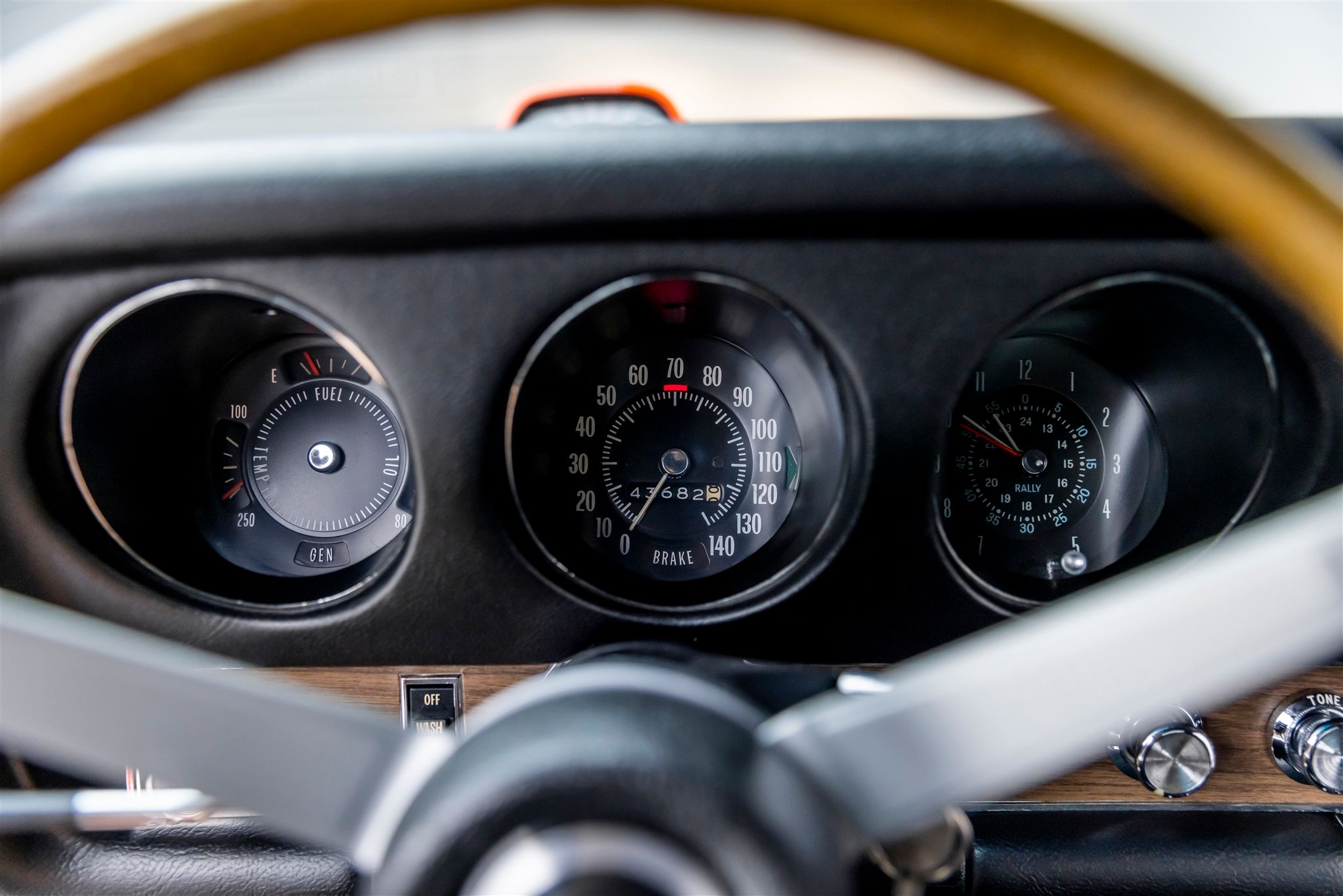 Instrument panel of a 1969 Pontiac GTO Judge with Rally Instrument cluster, clock, and hood-mounted tachometer