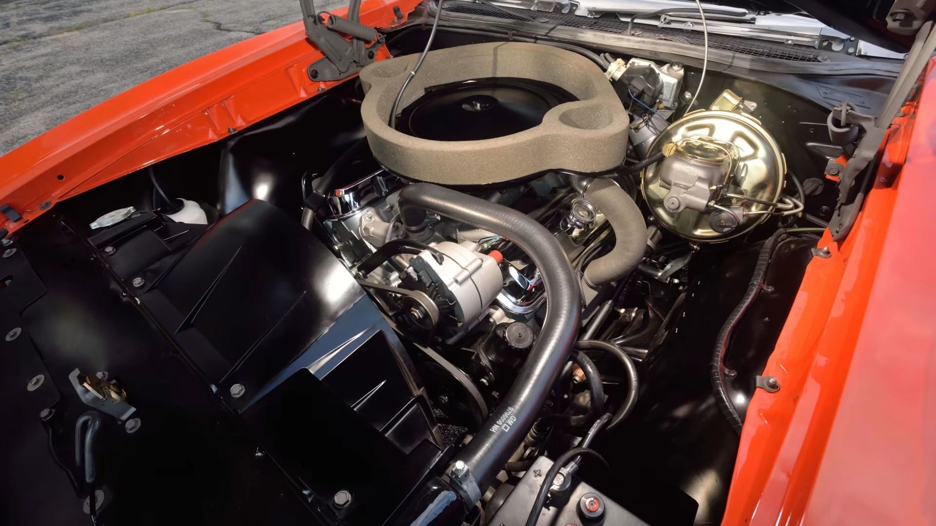 Ram Air IV engine under the hood of a Carousel Red 1969 Pontiac GTO Judge