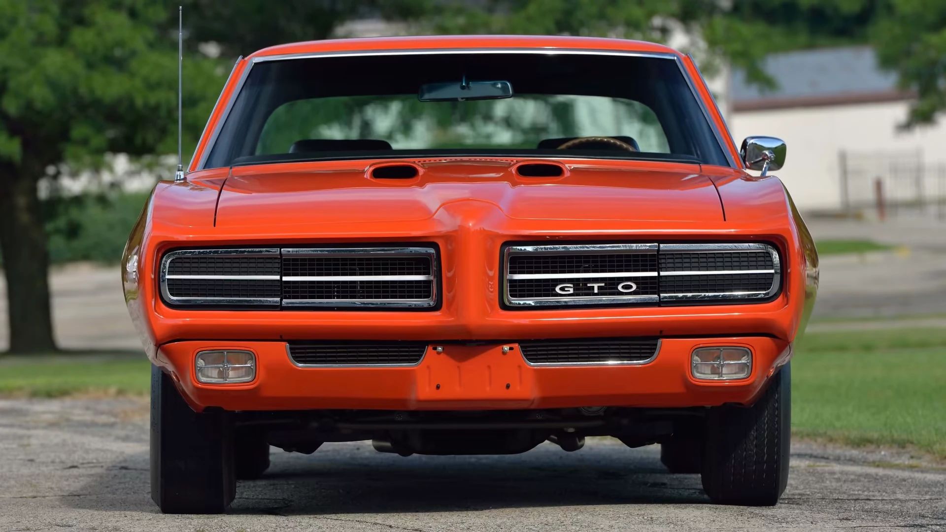 Front view of a Carousel Red 1969 Pontiac GTO Judge with concealed headlamps and Endura nose