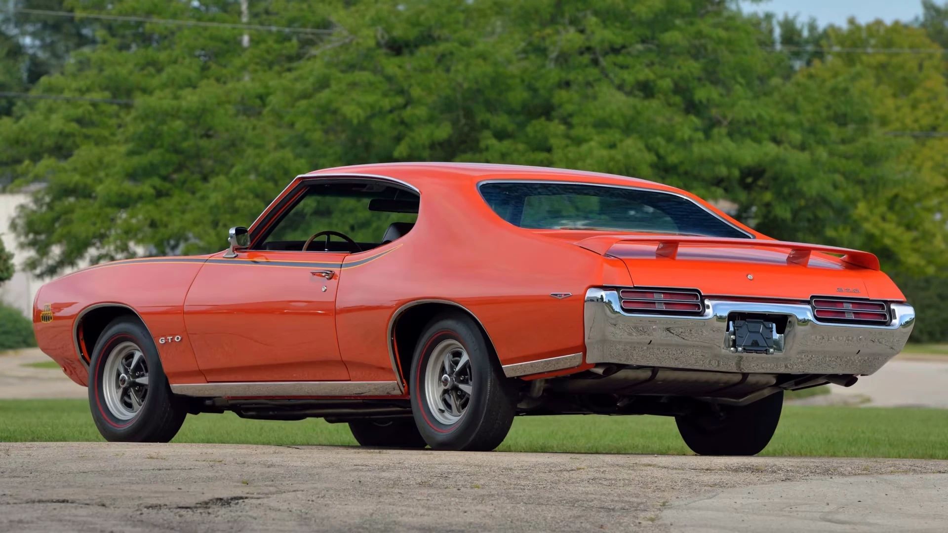 Left rear 3q view of a Carousel Red 1969 Pontiac GTO Judge hardtop
