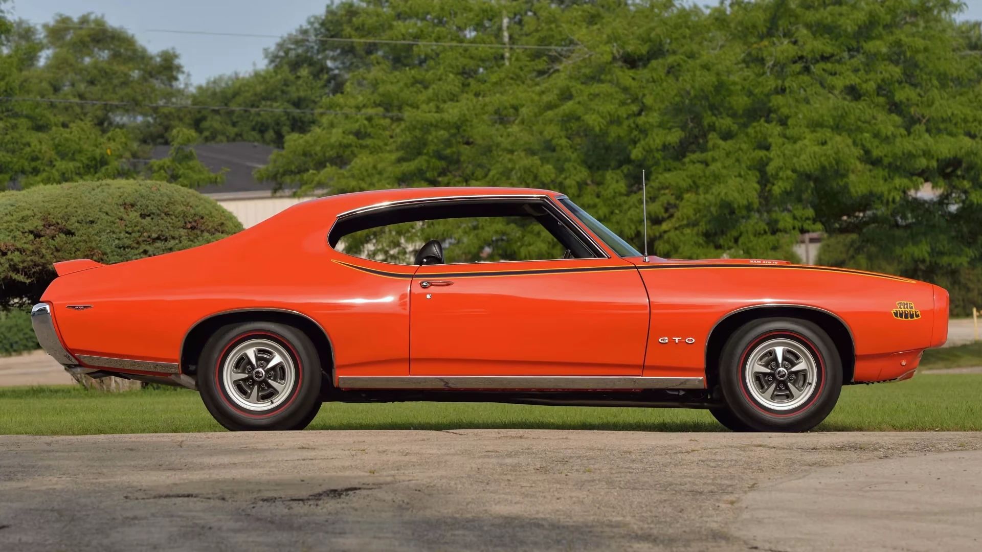 Left side view of a Carousel Red 1969 Pontiac GTO Judge hardtop
