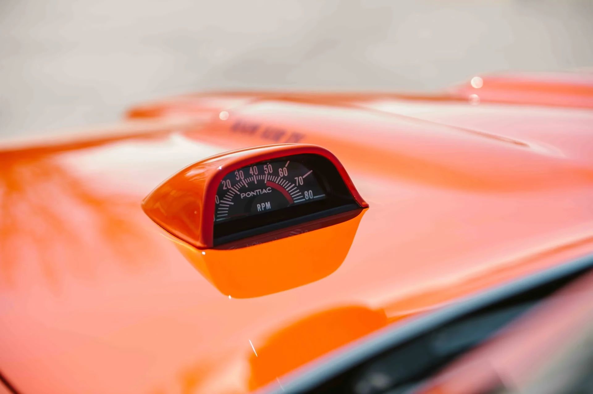 Hood-mounted tachometer on a Carousel Red 1969 Pontiac GTO Judge