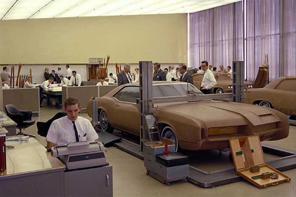 1966 Buick Riviera Versus 1966 Oldsmobile Toronado – Closely Related, Yet So Different (Part 1) 2 Color photo of the GM Body Development Studio, with designers in white shirts and ties working around several full-size clay models, including one that appears to be a 1966 Riviera on the right side and a 1966 Toronado on the left