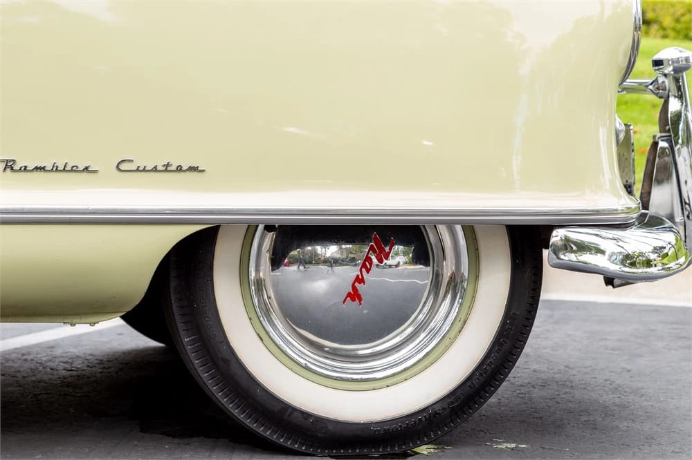 1950 Nash Rambler Convertible Landau: Adorable, Thrifty, But Not Cheap 9 Right front fender of an ivory 1950 Nash Rambler, showing the "Rambler Custom" script, wheel disc, and whitewall tire
