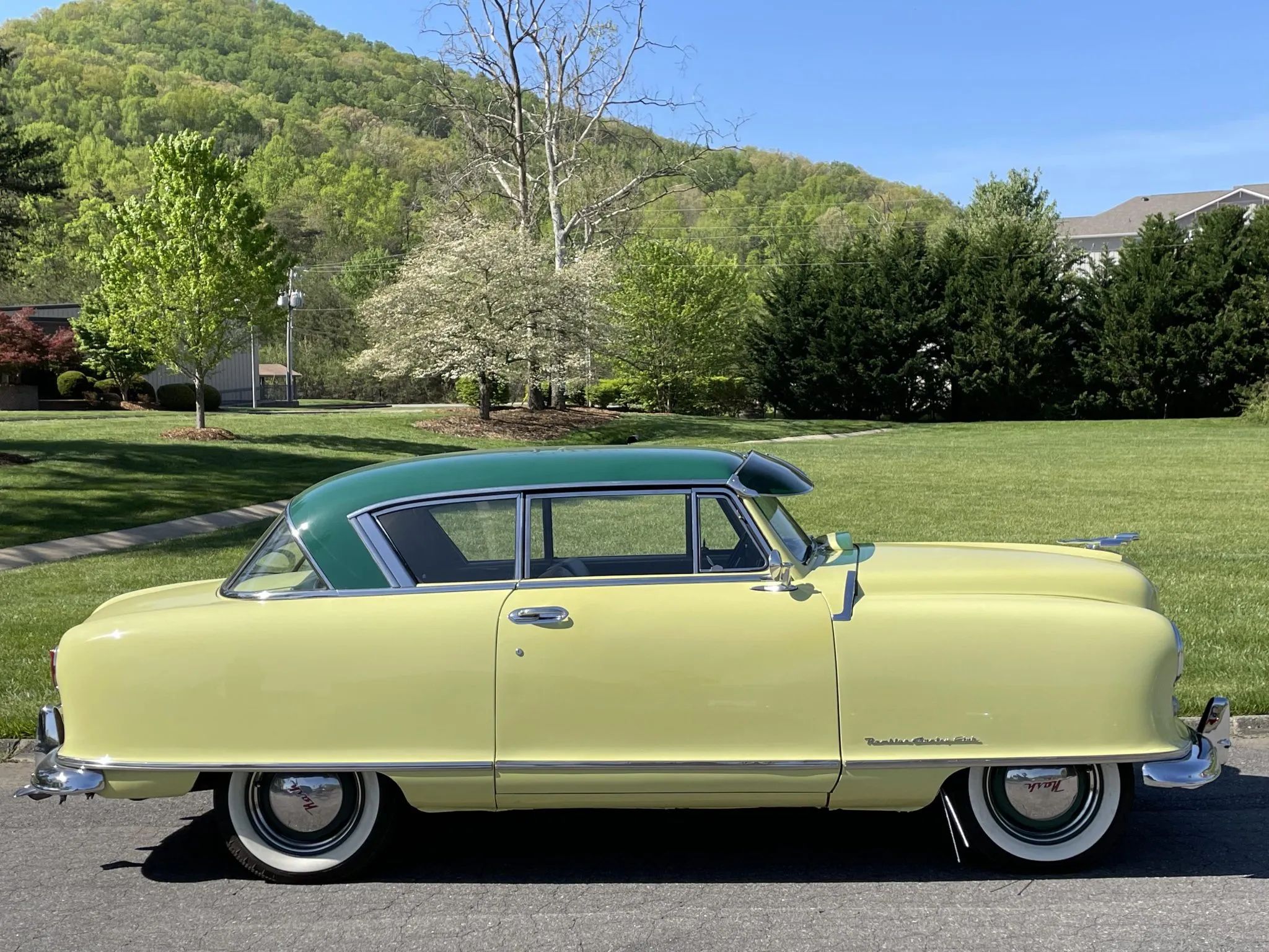 1950 Nash Rambler Convertible Landau: Adorable, Thrifty, But Not Cheap 31 Right side view of a yellow 1951 Nash Rambler Country Club hardtop with a green roof and curb feelers, in a park
