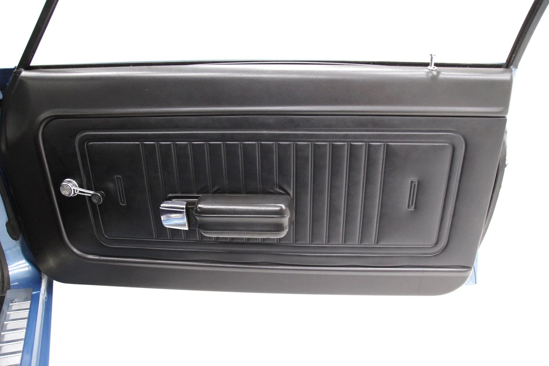 Passenger door trim of a 1970 Ford Maverick with black vinyl trim