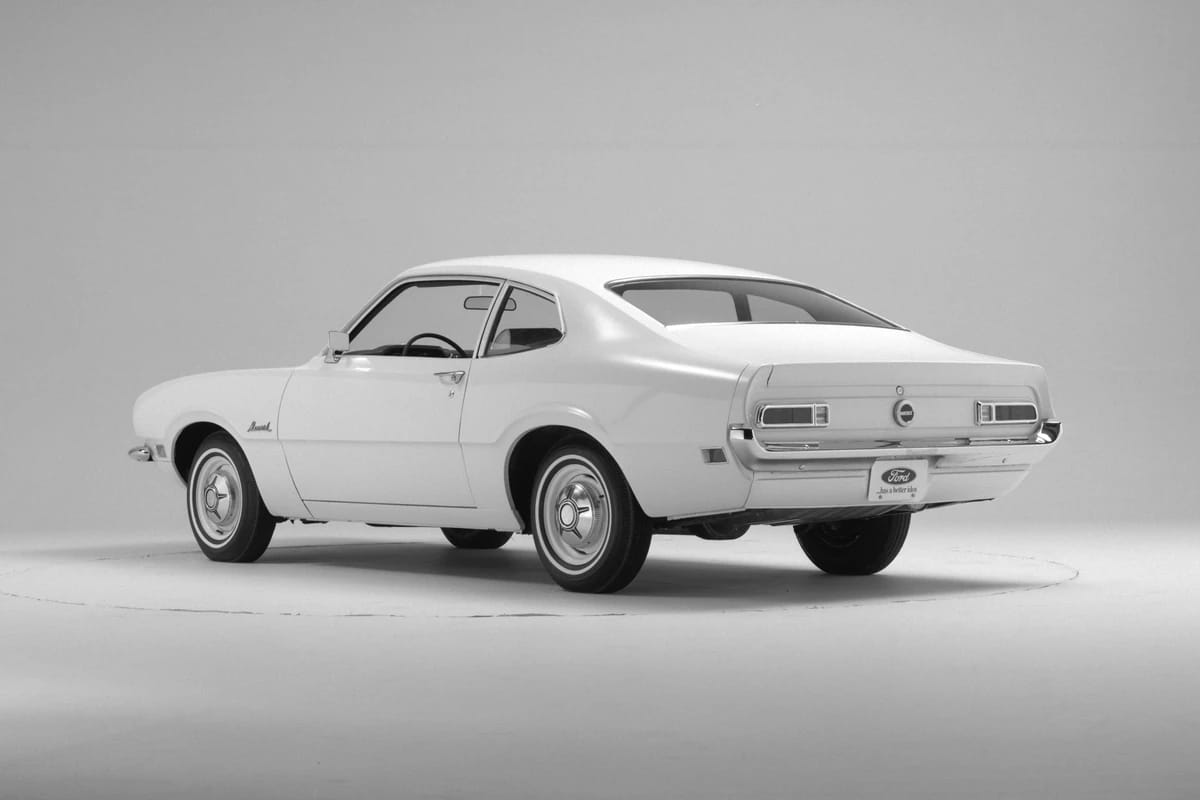 CC Tech: How the Mustang, Cougar, And Maverick Differed From The Original Ford Falcon Platform 35 Studio left rear 3q view of a white 1970 Ford Maverick with whitewalls and deluxe wheel covers