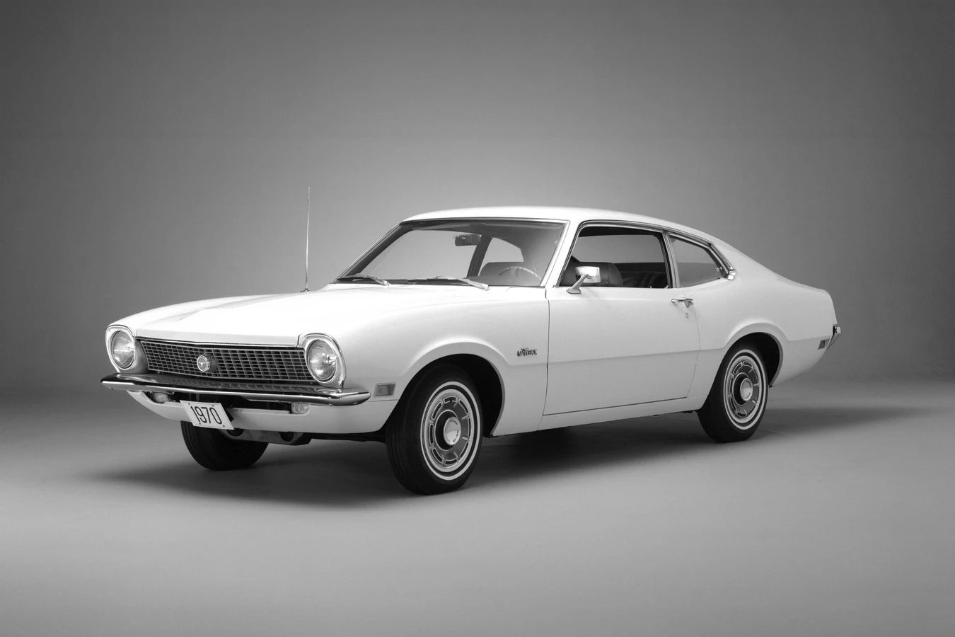 CC Tech: How the Mustang, Cougar, And Maverick Differed From The Original Ford Falcon Platform 30 Studio left front 3q view of a white 1970 Ford Maverick with whitewalls and deluxe wheel covers