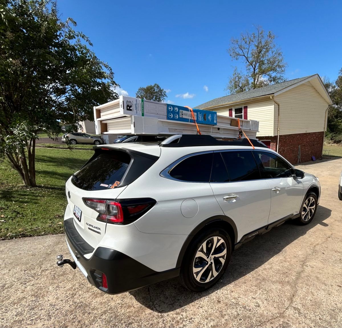 My 2024 Nissan Armada Platinum 3 Subaru Outback with closet doors on the roof rack