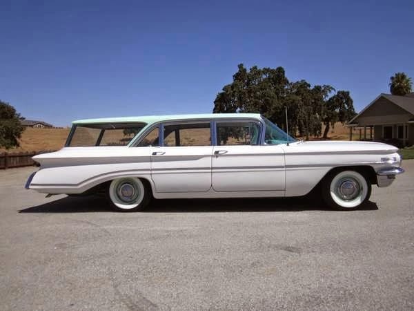 Right side view of a white 1960 Oldsmobile Dynamic 88 with a light green roof