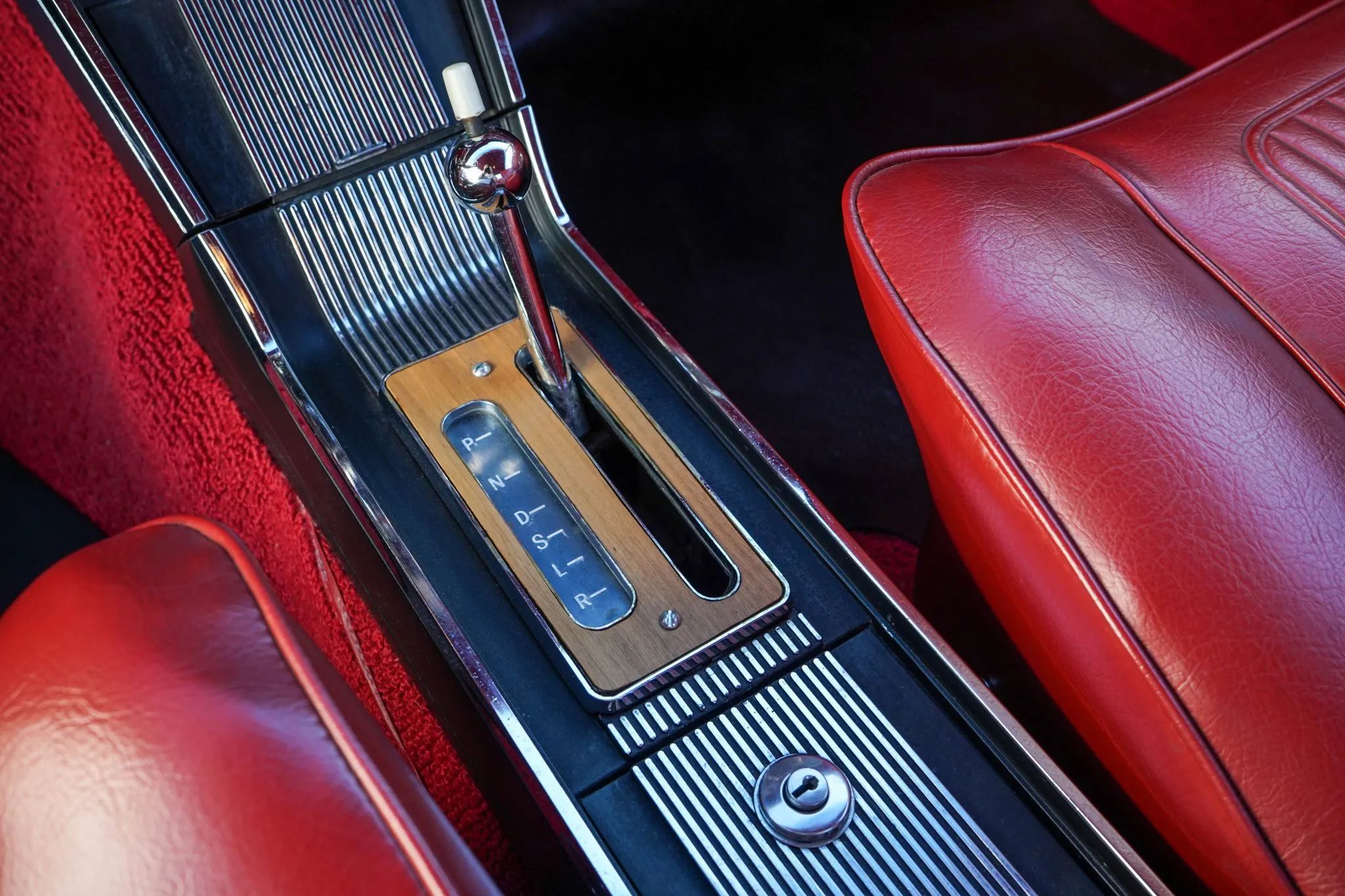 Hydra-Matic shifter on the console of a 1964 Pontiac Grand Prix with red vinyl upholstery