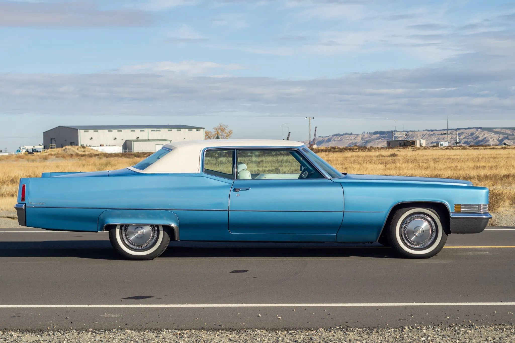 Decade De Ville: Cadillac's Bestselling '70s De Villes 7 Right side view of a blue 1970 Cadillac Coupe de Ville with a white vinyl top