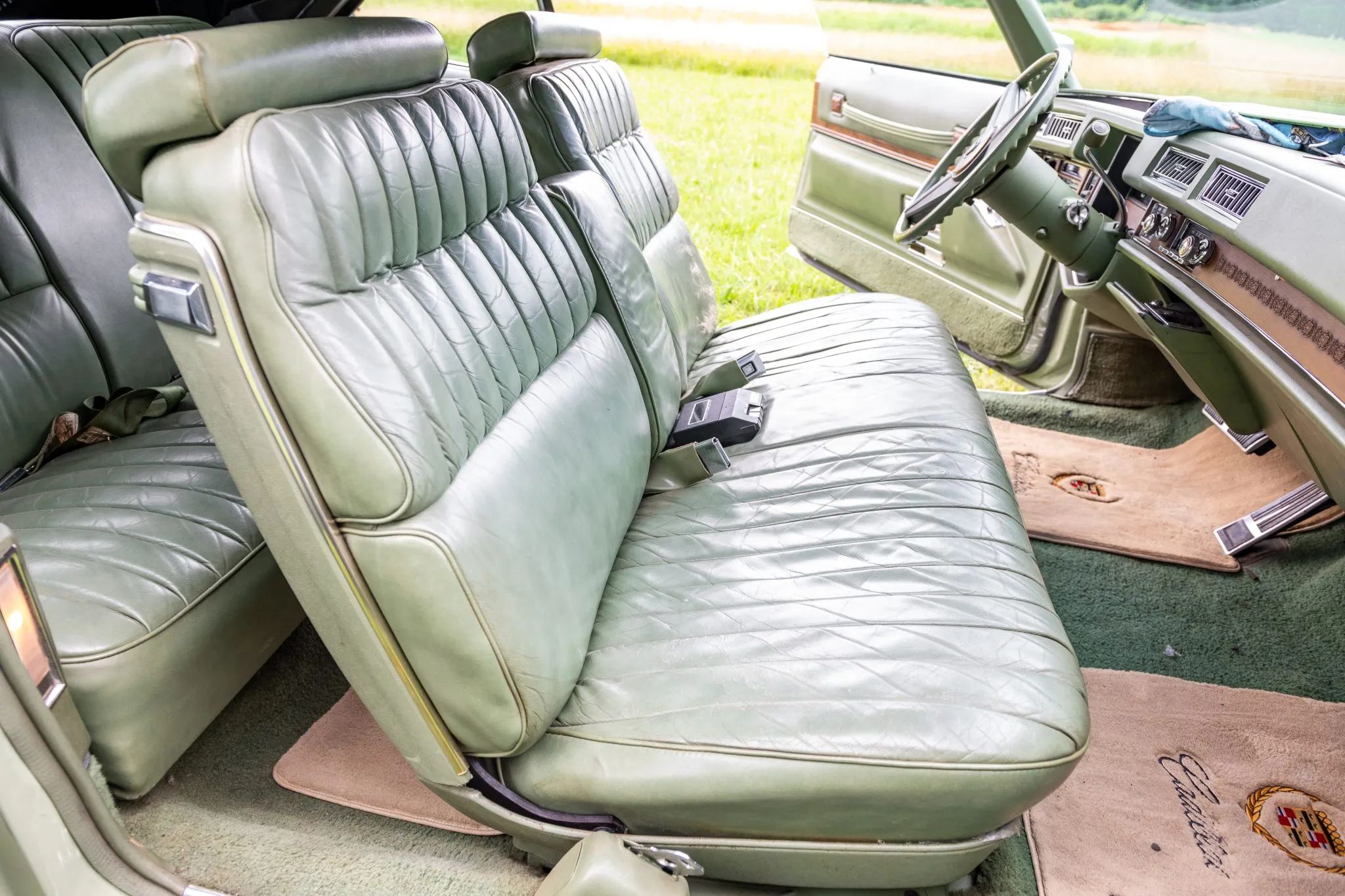 Front seat of a 1974 Cadillac Eldorado with green leather