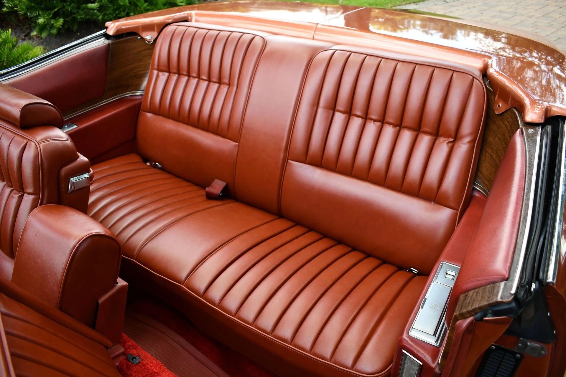 Back seat of a 1974 Cadillac Eldorado convertible with orange leather