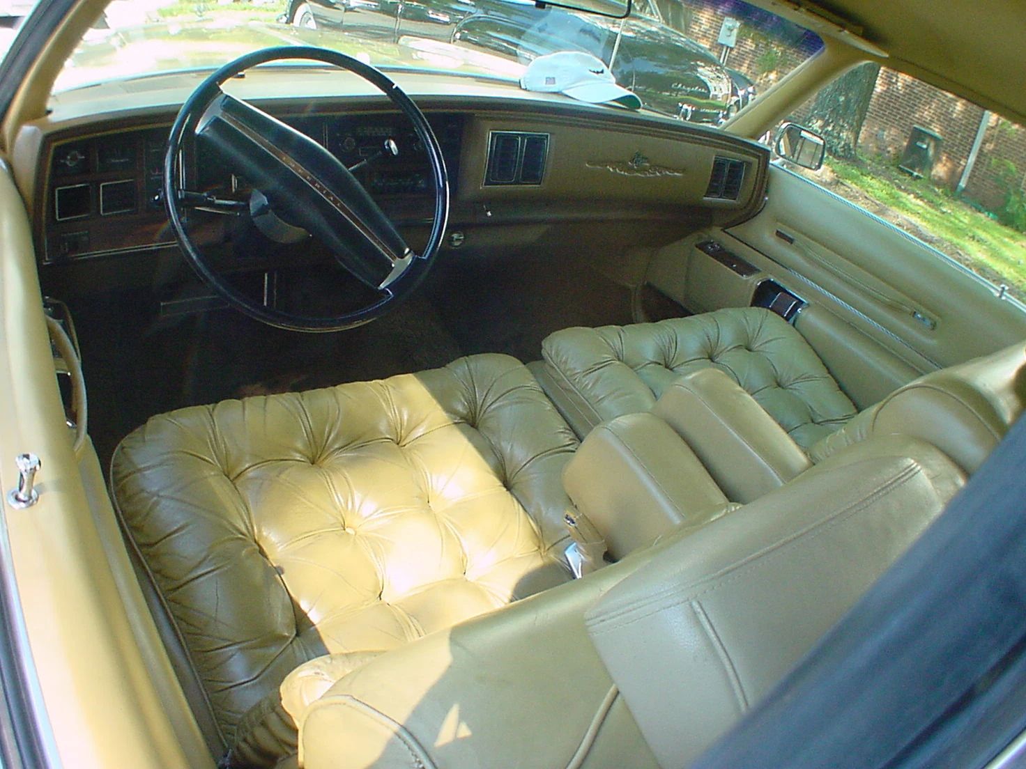 Front seat and dashboard of a 1974 Imperial LeBaron with gold leather upholstery