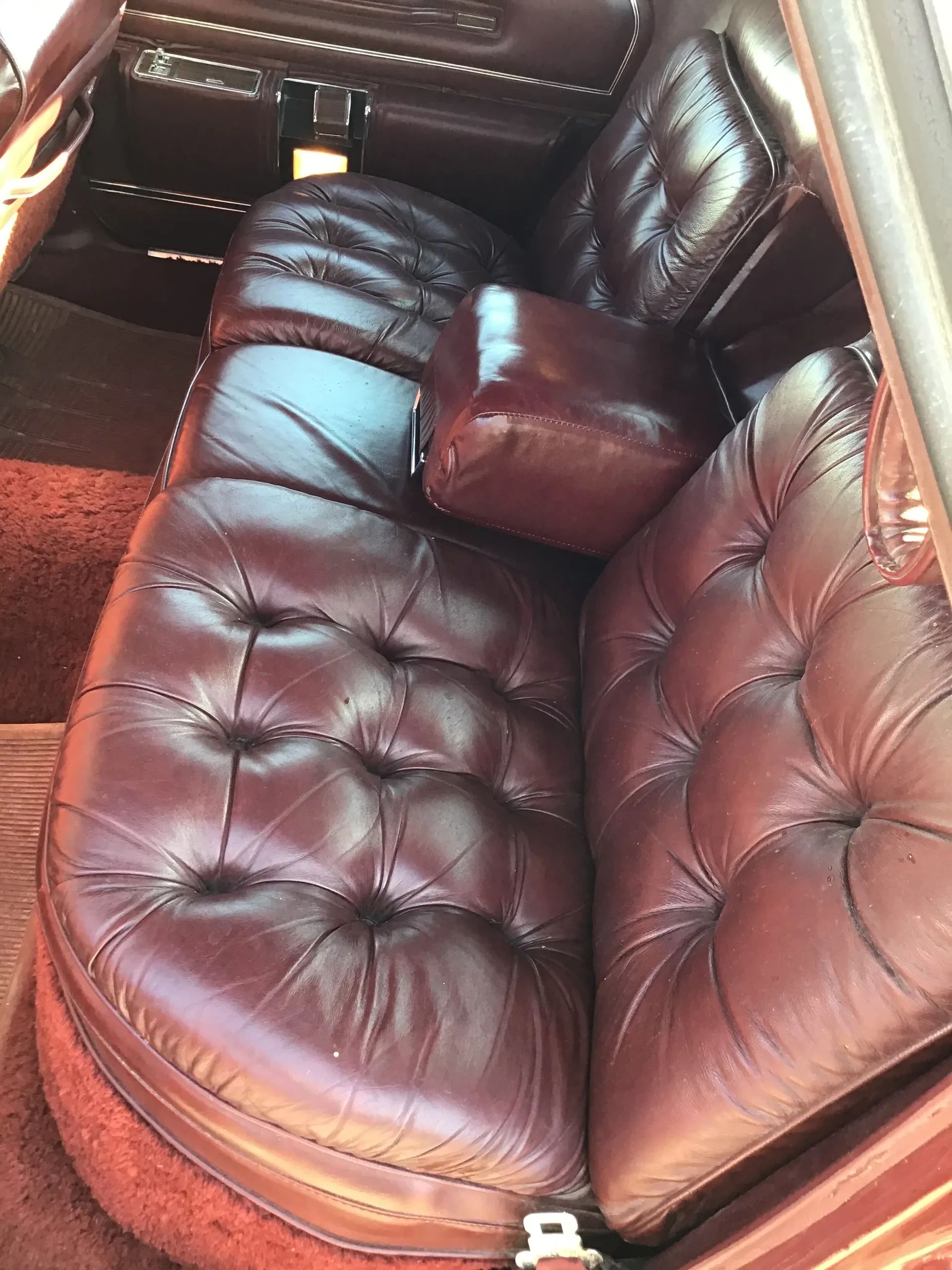 Back seat of a 1975 Imperial LeBaron with burgundy leather