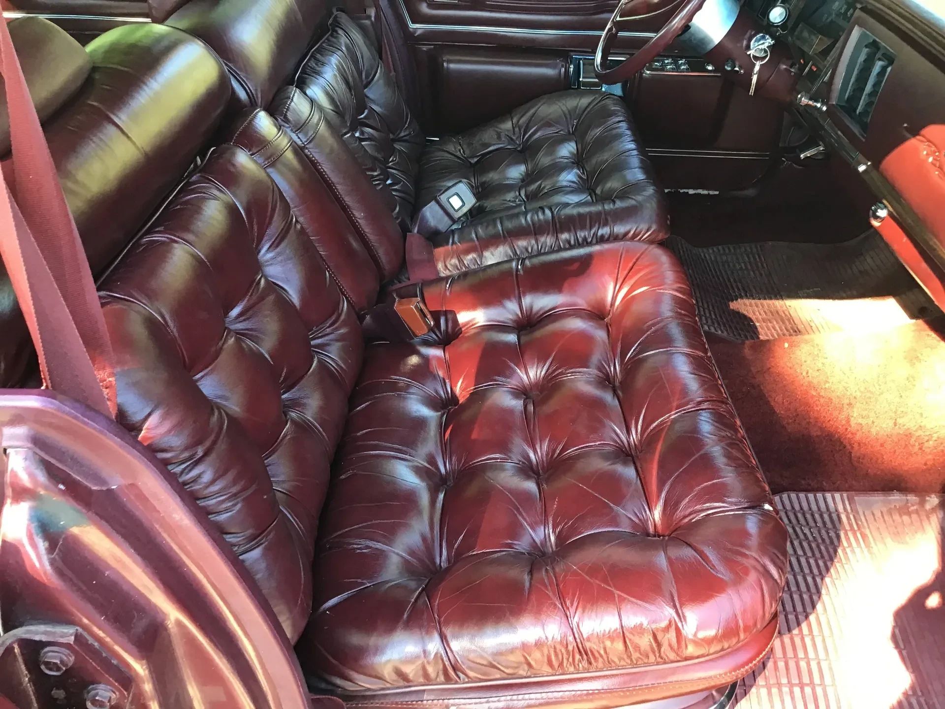 Front seat of a 1975 Imperial Lebaron with burgundy leather