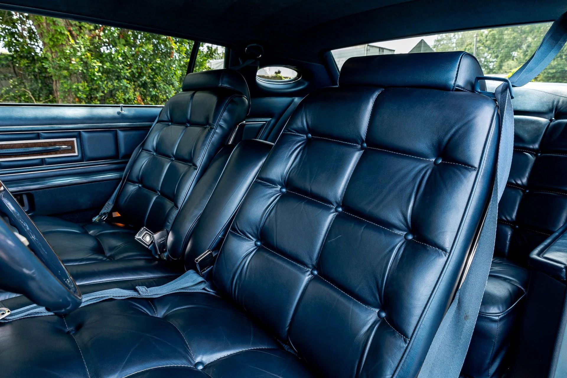 Front seat of a 1975 Lincoln Continental Mark V with dark blue leather upholstery