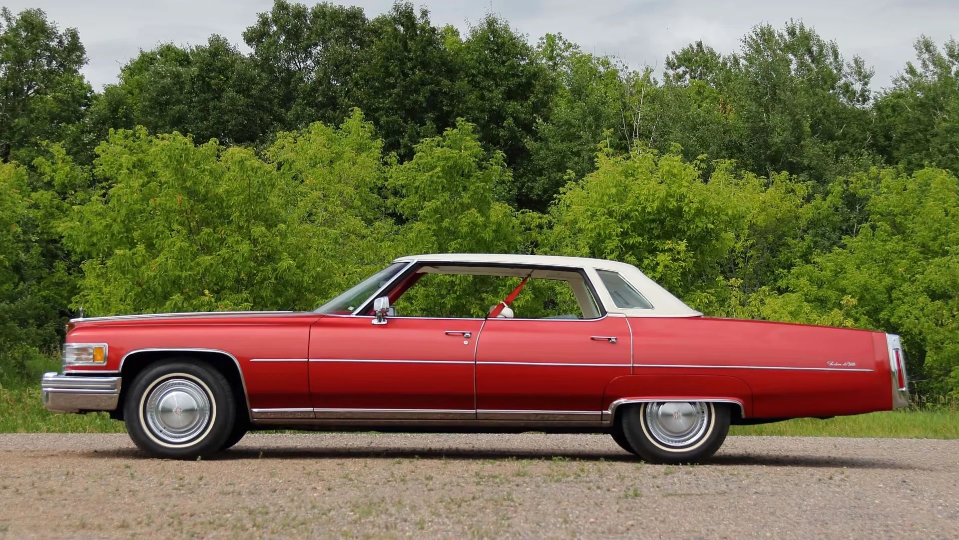 Decade De Ville: Cadillac's Bestselling '70s De Villes 14 Left side view of a red 1976 Cadillac Sedan de Ville with a white vinyl top