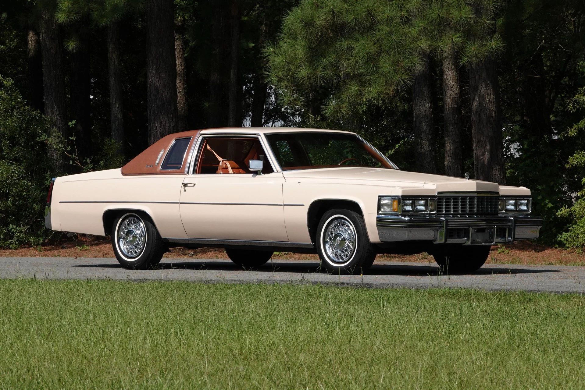 Decade De Ville: Cadillac's Bestselling '70s De Villes 15 Right front 3q view of a beige 1977 Cadillac Coupe de Ville with a brown vinyl top and wire wheel covers