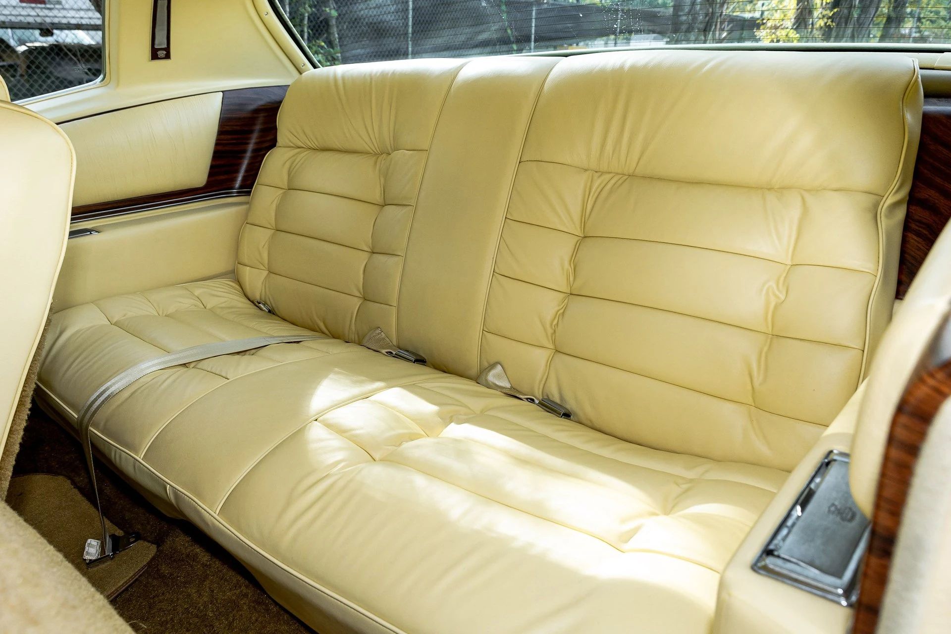 Back seat of a 1978 Cadillac Eldorado with yellow leather