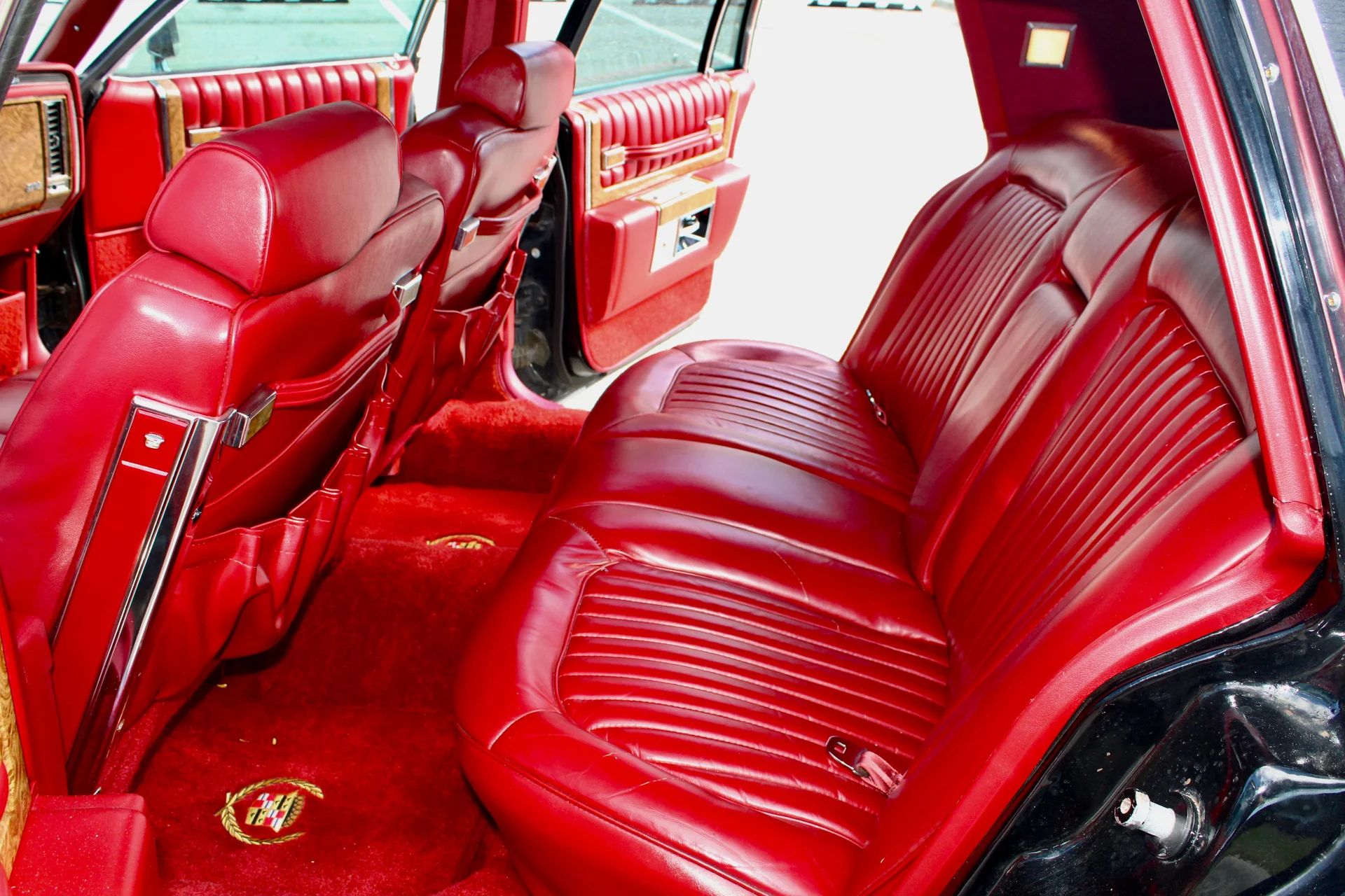 Back seat of a 1979 Cadillac Sedan de Ville with red leather