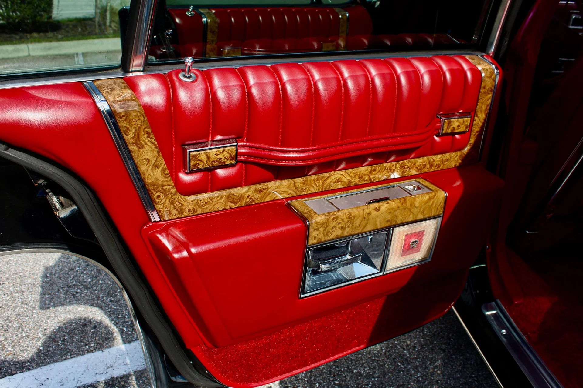 Driver's door trim on a 1979 Cadillac Sedan de Ville with red leather interior