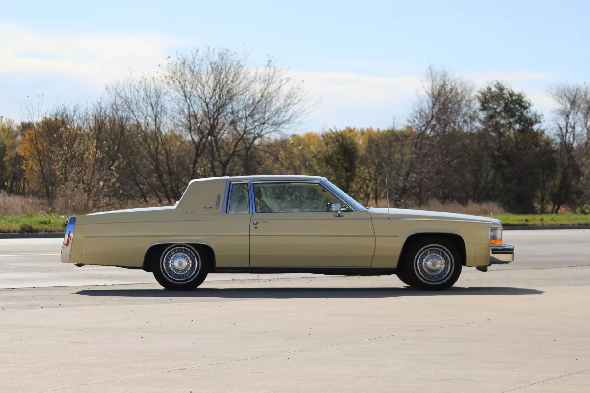 Decade De Ville: Cadillac's Bestselling '70s De Villes 18 Right side view of a yellow 1980 Cadillac Coupe de Ville with a yellow vinyl top
