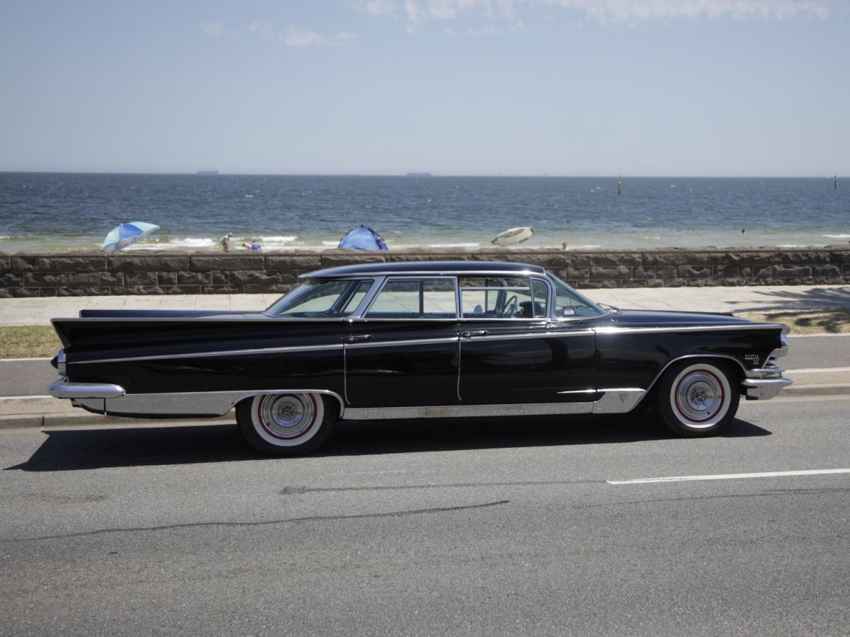 Full-Size Buicks Of The 1960s: How Buick Reinvented Its Lineup Between 1959 And 1970 8 Right side view of a black 1959 Buick Electra 225 four-door hardtop with a beach in the background
